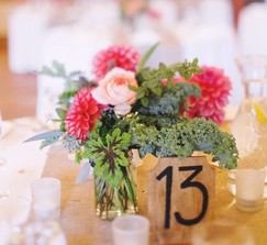 Rustic wooden table numbers in black calligraphy